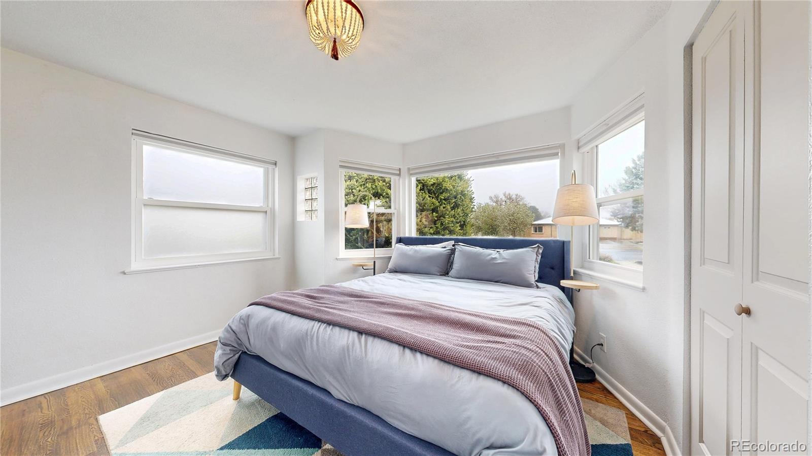 3155 Steele Street Denver, CO 80205 - Photo 10 of 37 a bedroom with a bed and a window