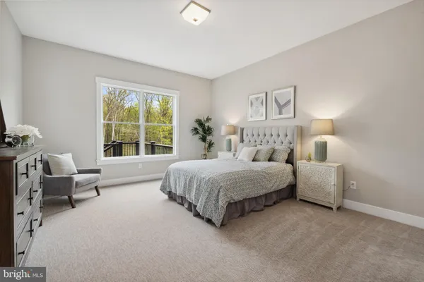 a bedroom with bed couch and window