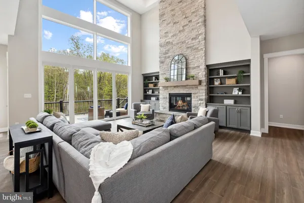 a living room with fireplace furniture and a floor to ceiling window