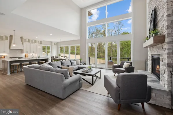 a living room with fireplace furniture and a large window