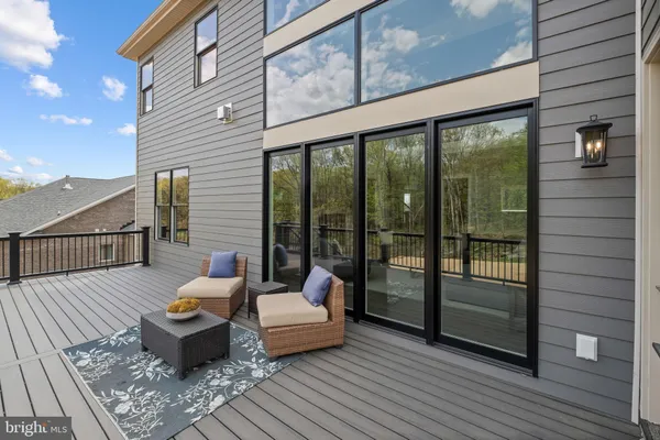 a balcony with furniture and wooden floor