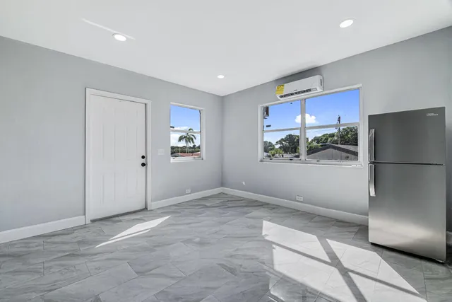 a view of an empty room with a kitchen