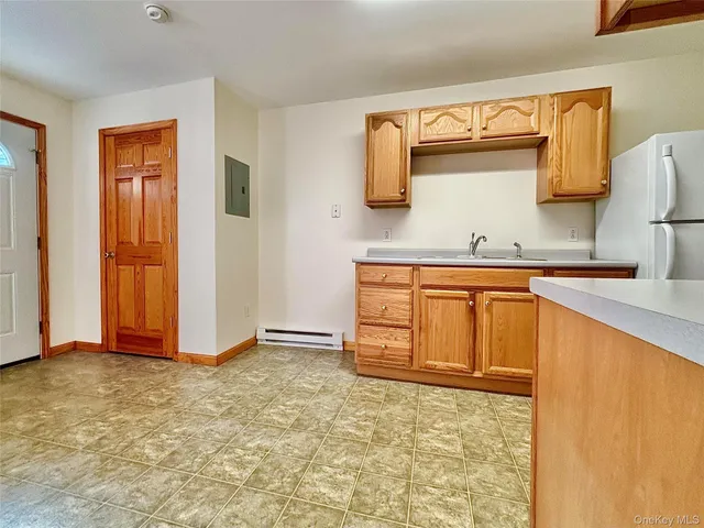 a view of a kitchen with wooden cabinets and a sink