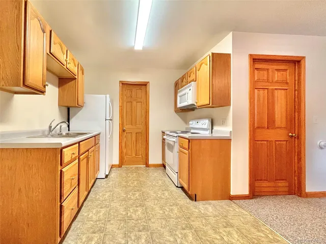 an empty room with a window and a ceiling fan