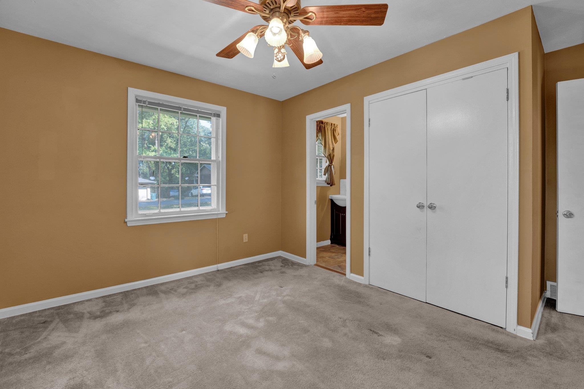4909 Lochinvar Road Memphis, TN 38116 - Photo 14 of 21 Primary Bedroom featuring double closet and half bath