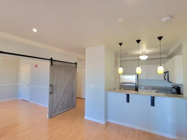 a kitchen with refrigerator and cabinets