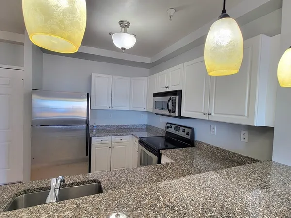 a kitchen with a sink a counter and a stove