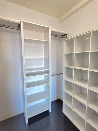 a view of walk in closet with empty racks