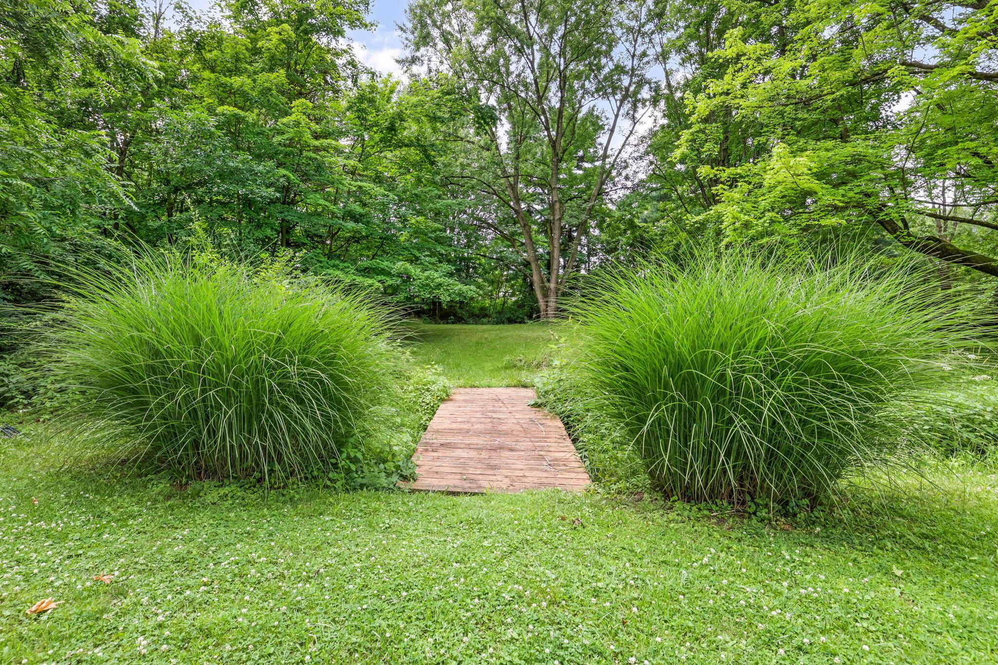14823 Cleveland Road Southwest Pataskala, OH 43062 - Photo 46 of 57 Lush green lawn with a natural wood plank pathway