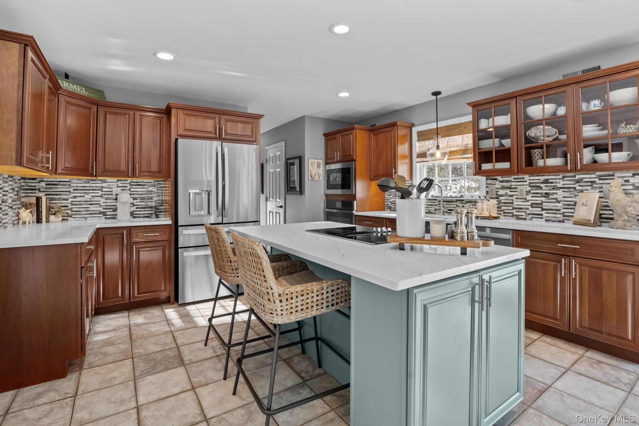 6 Ridge Circle Mahopac, NY 10541 - Photo 11 of 49 a kitchen with stainless steel appliances granite countertop a table chairs sink and cabinets