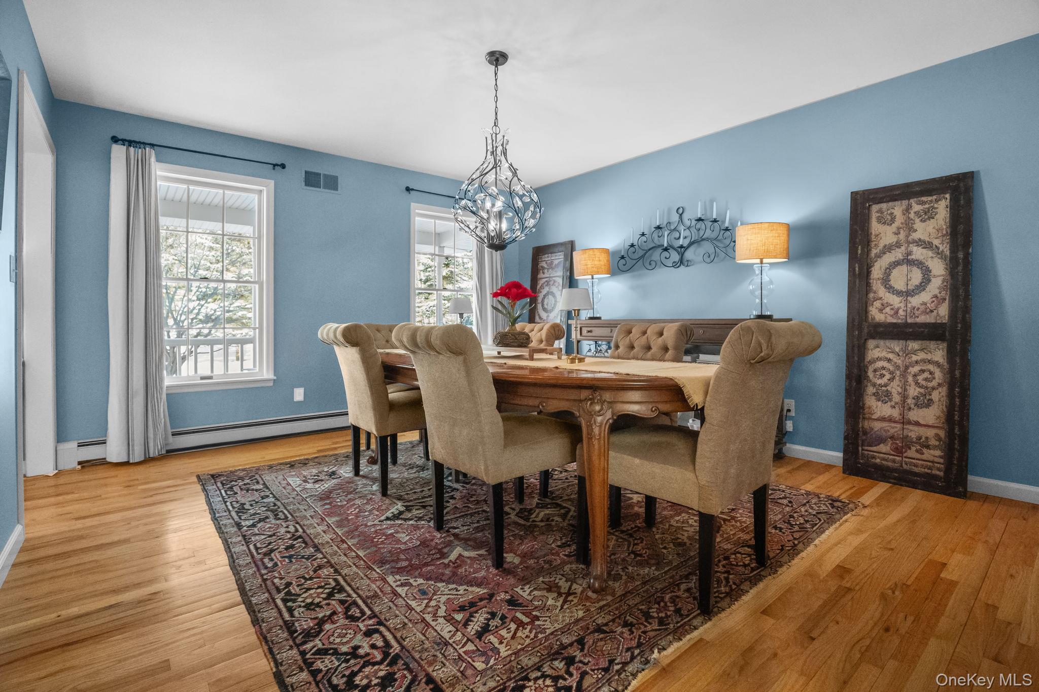 6 Ridge Circle Mahopac, NY 10541 - Photo 18 of 49 a dining room with furniture a chandelier and wooden floor