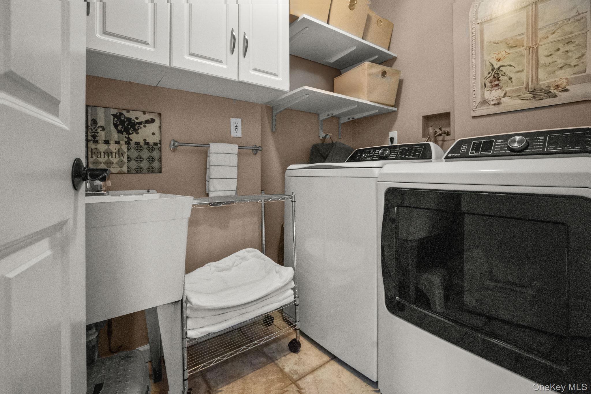 6 Ridge Circle Mahopac, NY 10541 - Photo 22 of 49 a utility room with dryer washer and a view of living room
