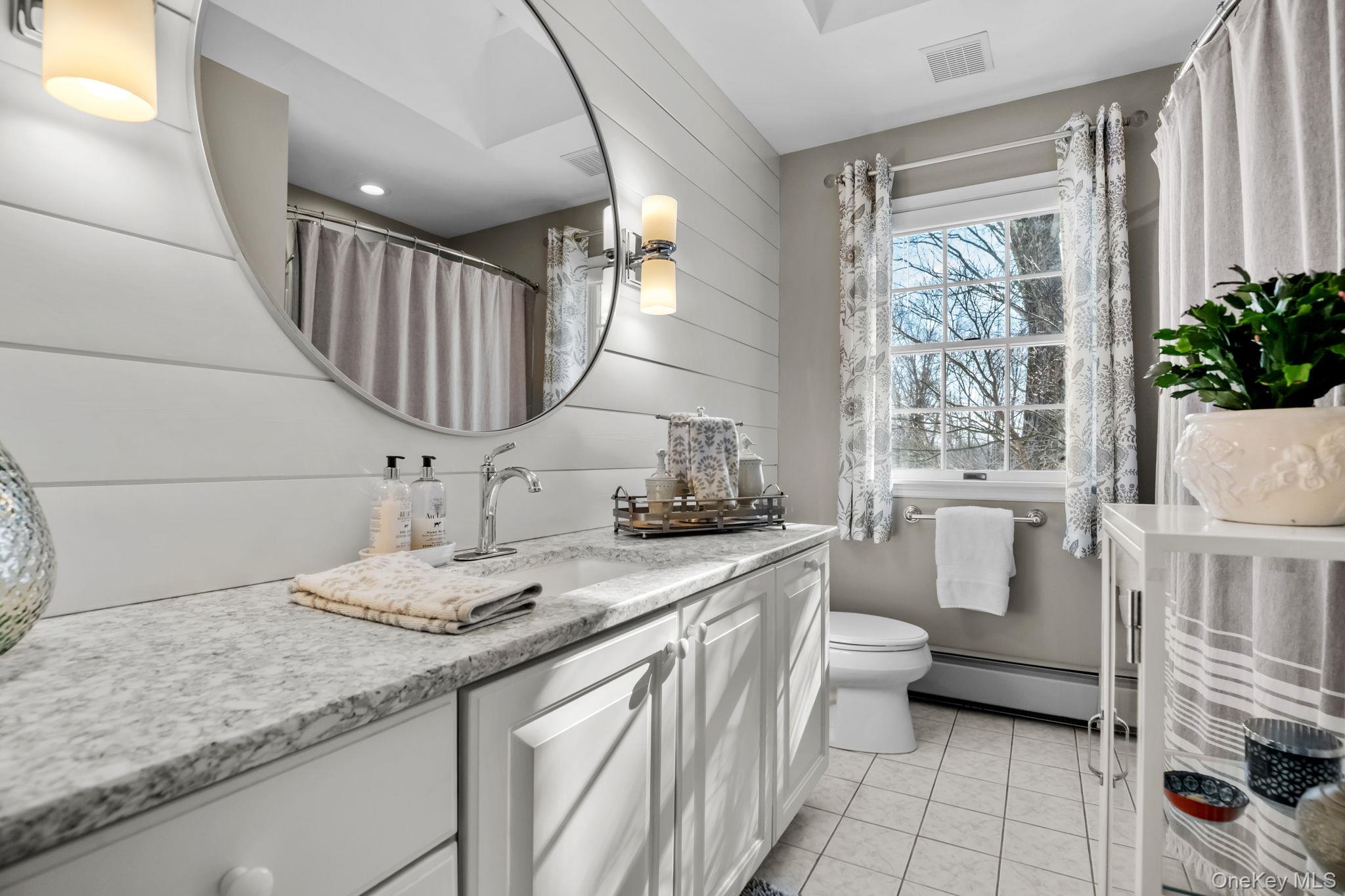 6 Ridge Circle Mahopac, NY 10541 - Photo 32 of 49 a bathroom with a granite countertop sink mirror vanity and toilet