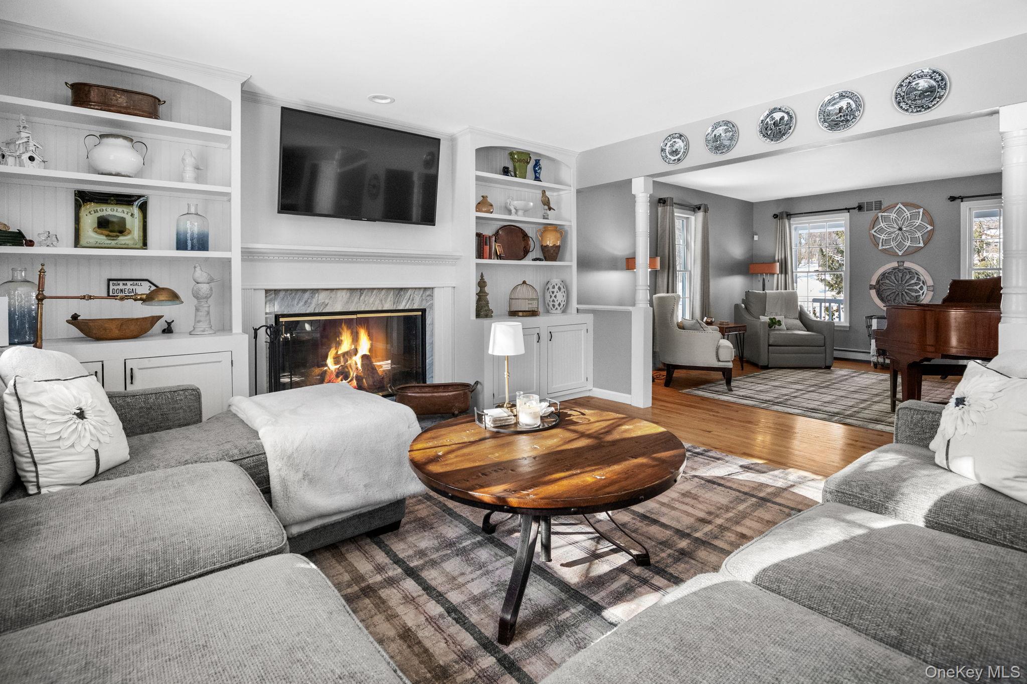 6 Ridge Circle Mahopac, NY 10541 - Photo 5 of 49 a living room with furniture a flat screen tv and a fireplace