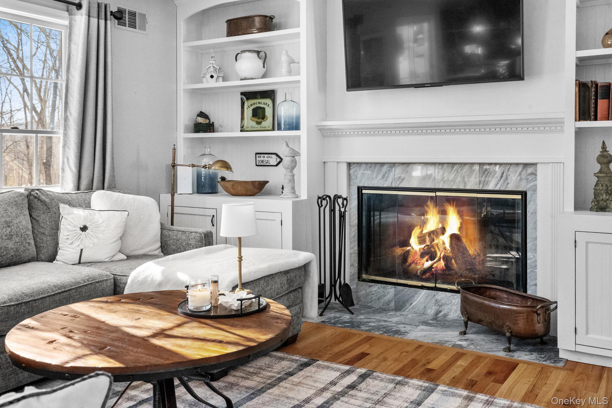 6 Ridge Circle Mahopac, NY 10541 - Photo 7 of 49 a living room with furniture a flat screen tv and a fireplace