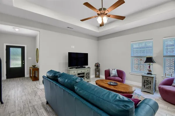 a view of a dining room with furniture and chandelier