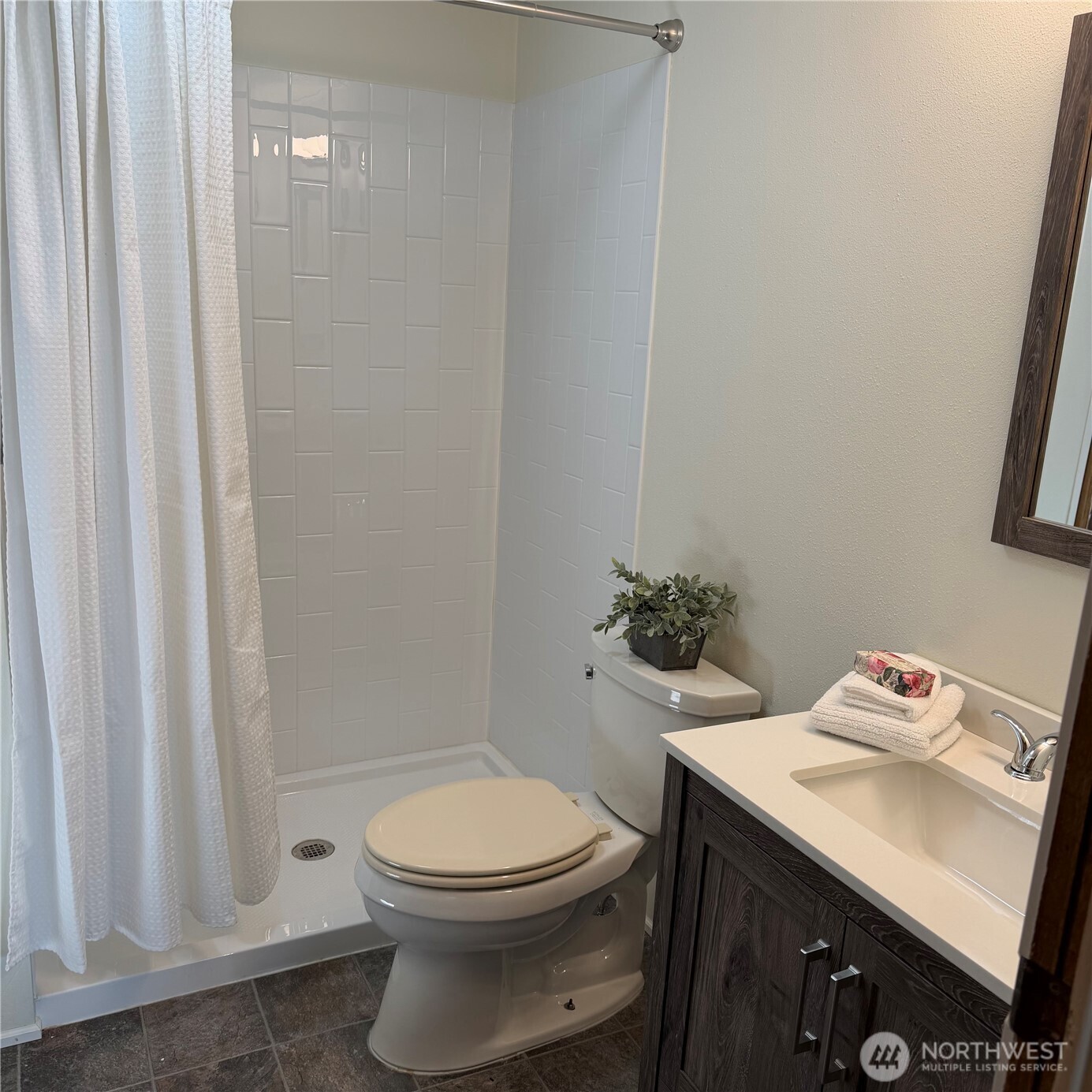920 Maple Street, Unit 11 Sedro-Woolley, WA 98284 - Photo 11 of 13 a bathroom with a sink a toilet and shower curtain
