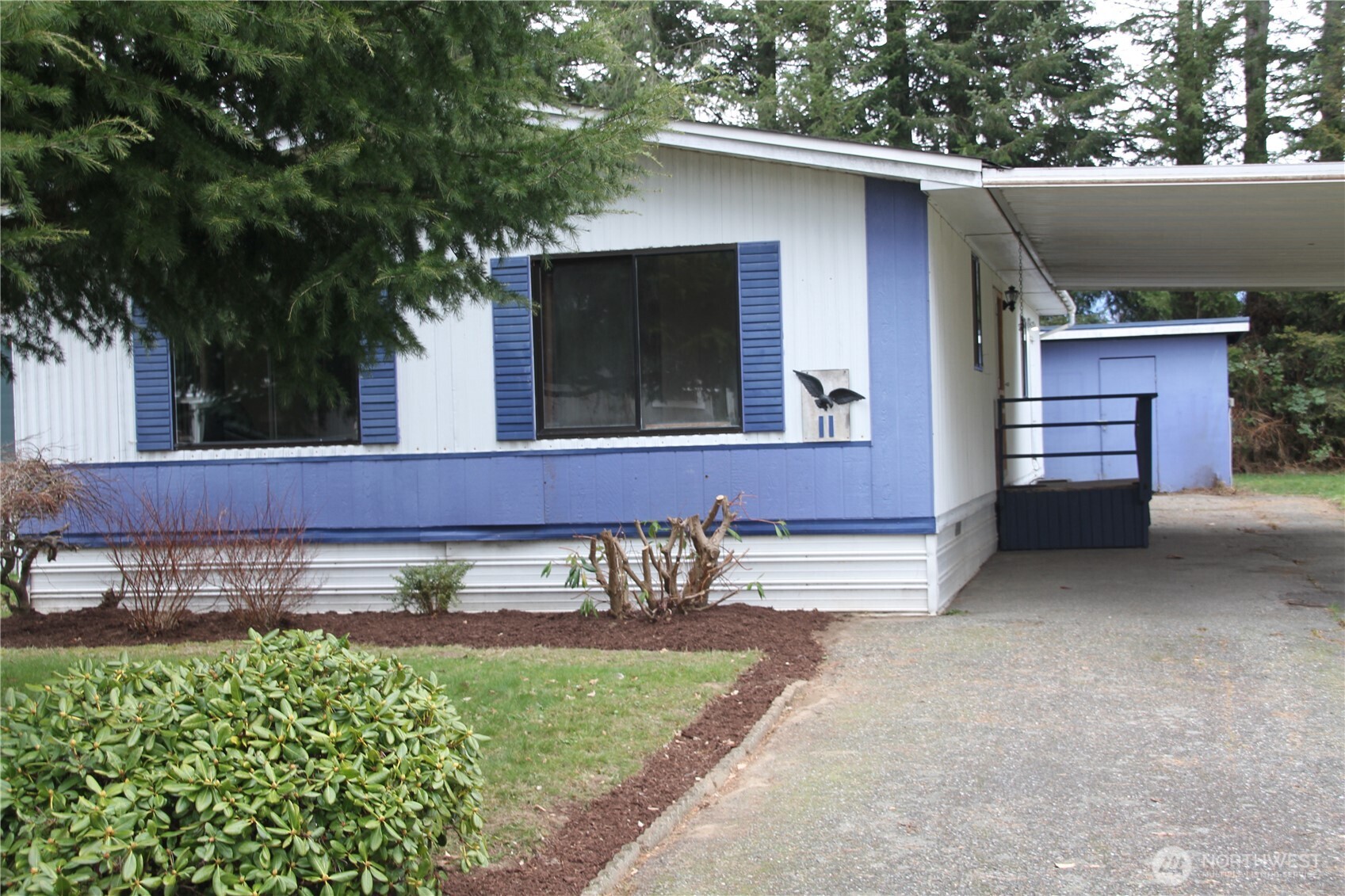 920 Maple Street, Unit 11 Sedro-Woolley, WA 98284 - Photo 13 of 13 a view of a house with a yard and a garden