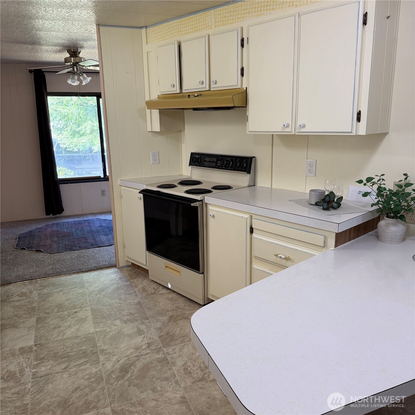 920 Maple Street, Unit 11 Sedro-Woolley, WA 98284 - Photo 2 of 13 a kitchen with stainless steel appliances a stove a refrigerator sink and cabinets