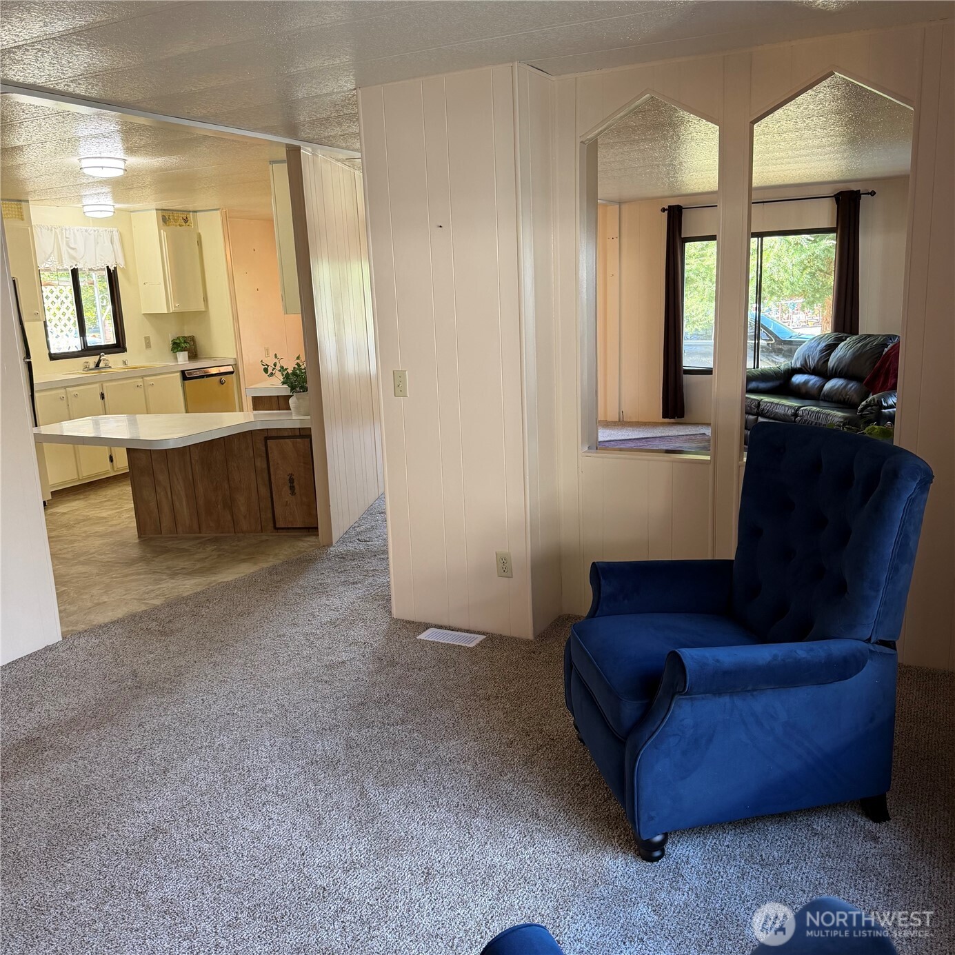 920 Maple Street, Unit 11 Sedro-Woolley, WA 98284 - Photo 9 of 13 a living room with furniture and a large mirror