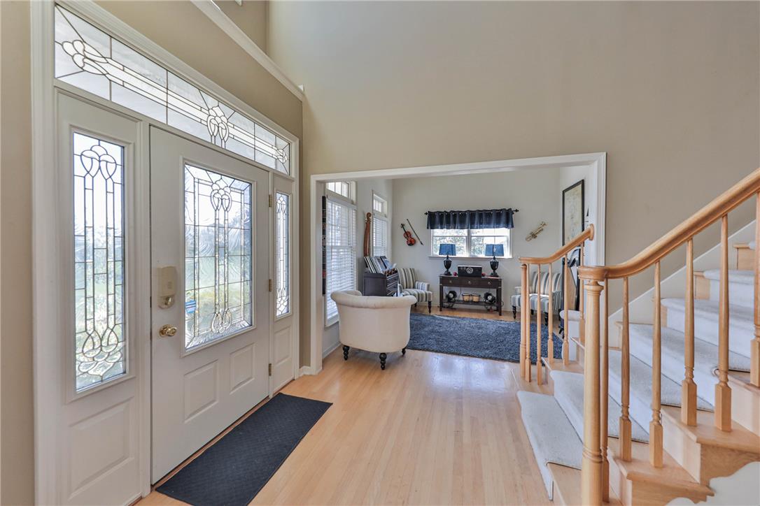 63 Long Road Lenhartsville, PA 19534 - Photo 27 of 100 An inviting entrance foyer showcases double-height ceilings, warm hardwood flooring, and a decorative glass front door.