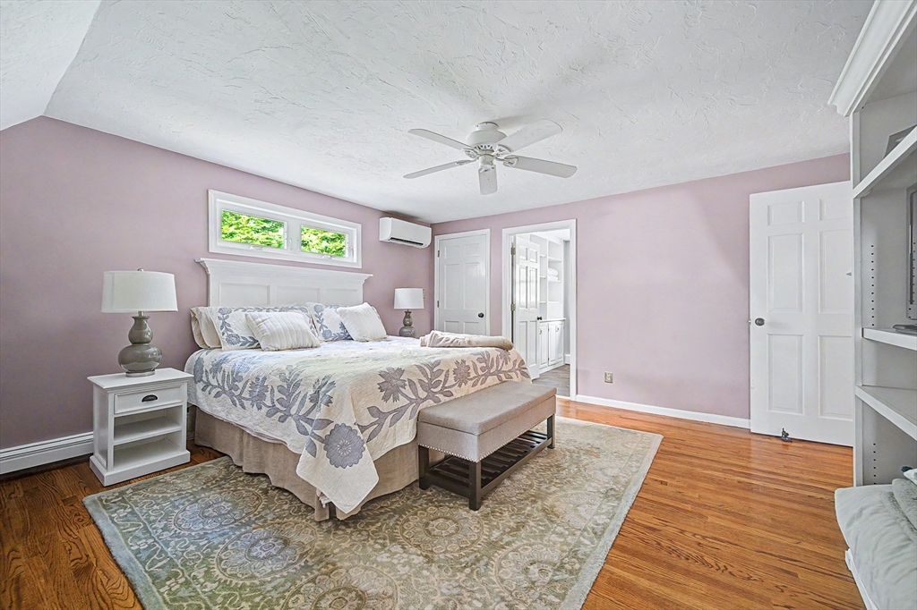 4 Dicarlo Road Hopkinton, MA 01748 - Photo 24 of 41 a spacious bedroom with a bed and a table in it