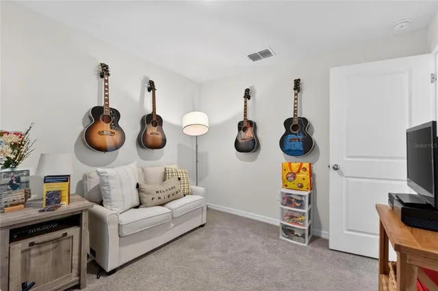 a living room with furniture and a mirror