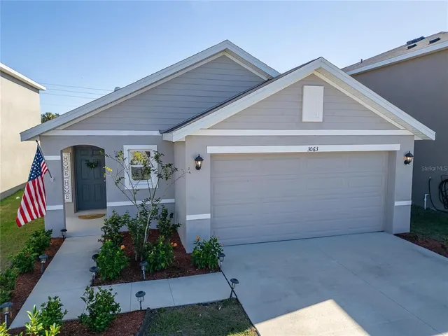 a front view of a house with plants