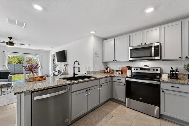 a kitchen with sink cabinets and stainless steel appliances