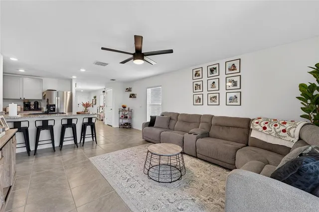 a living room with furniture and kitchen view