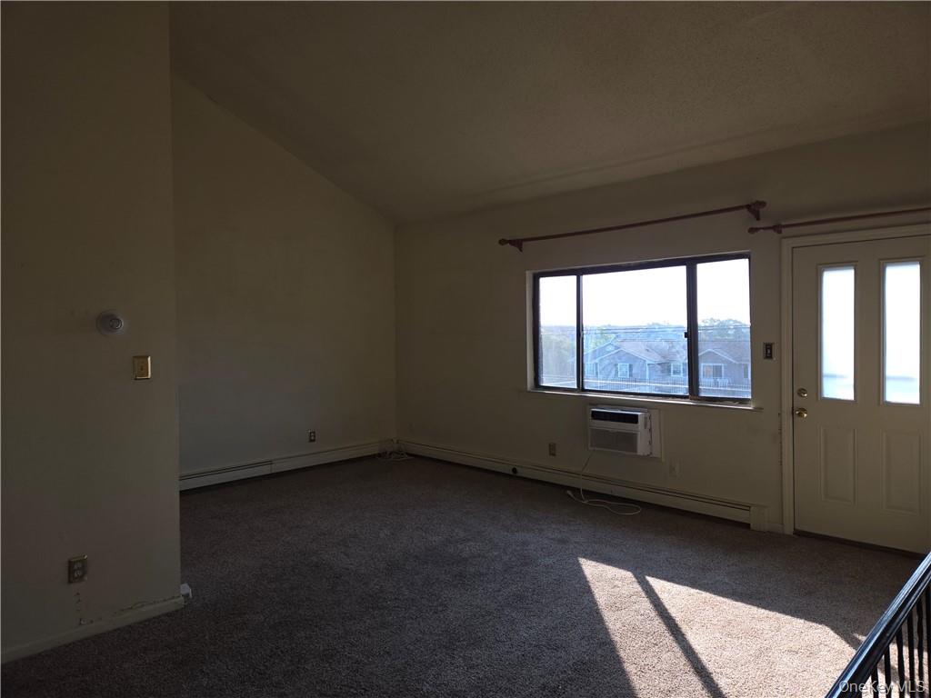 44 Inwood Road Middletown, NY 10941 - Photo 15 of 15 Entrance foyer featuring dark carpet, baseboard heating, a wall mounted air conditioner, and vaulted ceiling