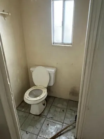 a white toilet sitting in a bathroom