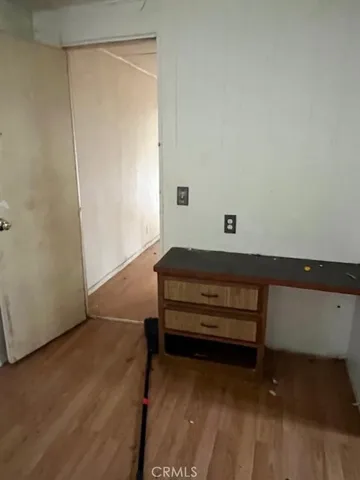 a sitting area with wooden floor