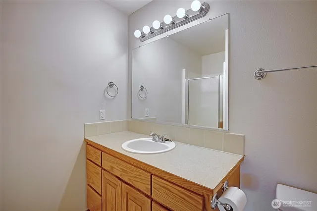 a bathroom with a sink a light fixture and a mirror