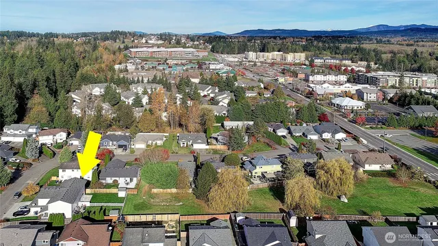 an aerial view of residential houses with outdoor space and swimming pool