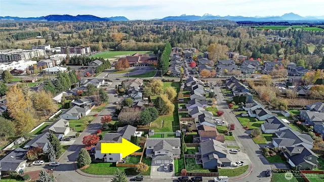 an aerial view of residential house with an outdoor space and lake view