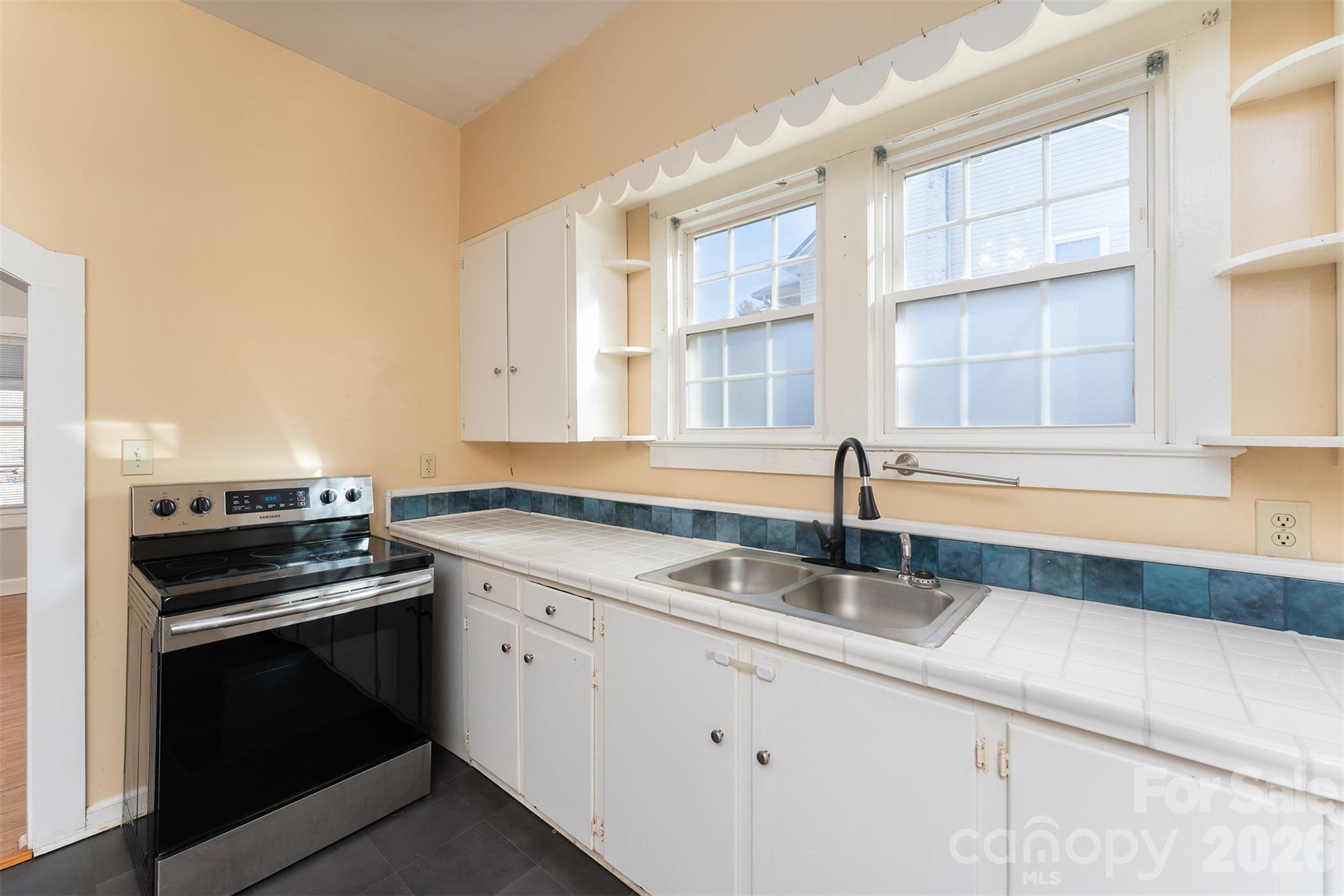 20 1st Street Marion, NC 28752 - Photo 11 of 23 a kitchen with a sink stove and cabinets