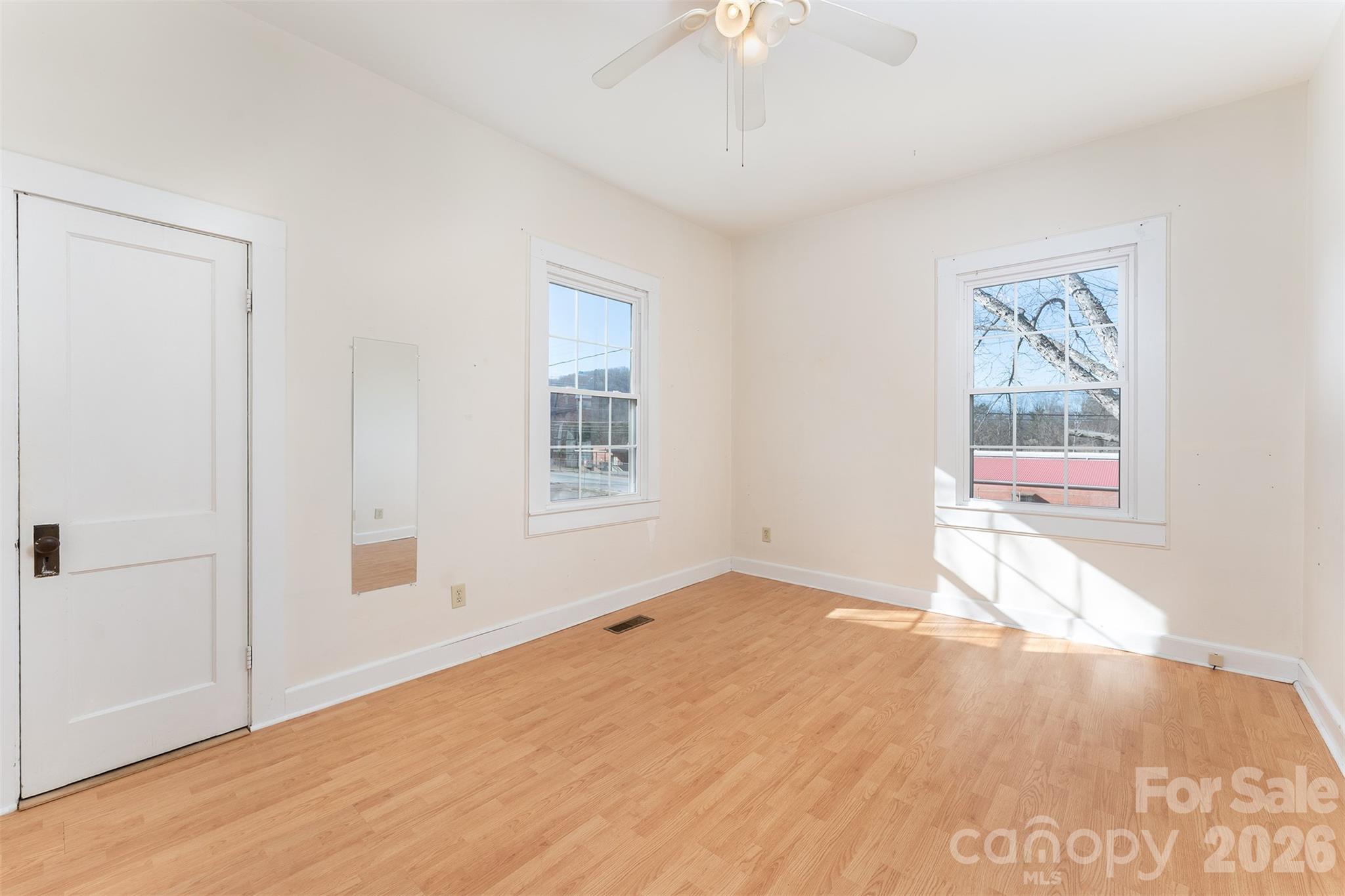 20 1st Street Marion, NC 28752 - Photo 13 of 23 wooden floor in an empty room with a window