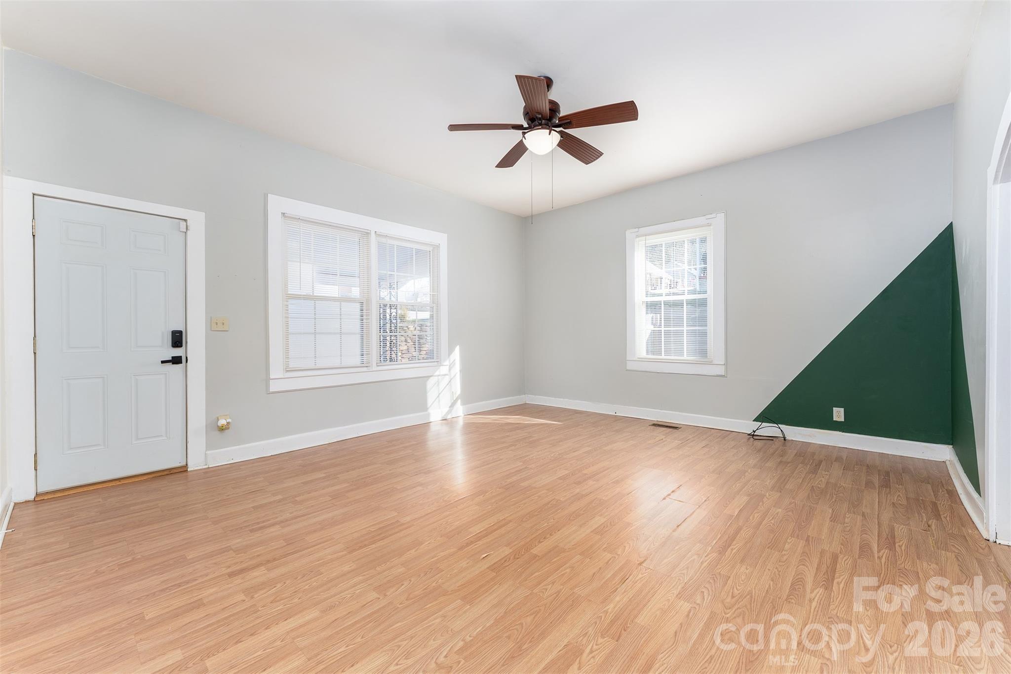 20 1st Street Marion, NC 28752 - Photo 5 of 23 a view of empty room with wooden floor and fan