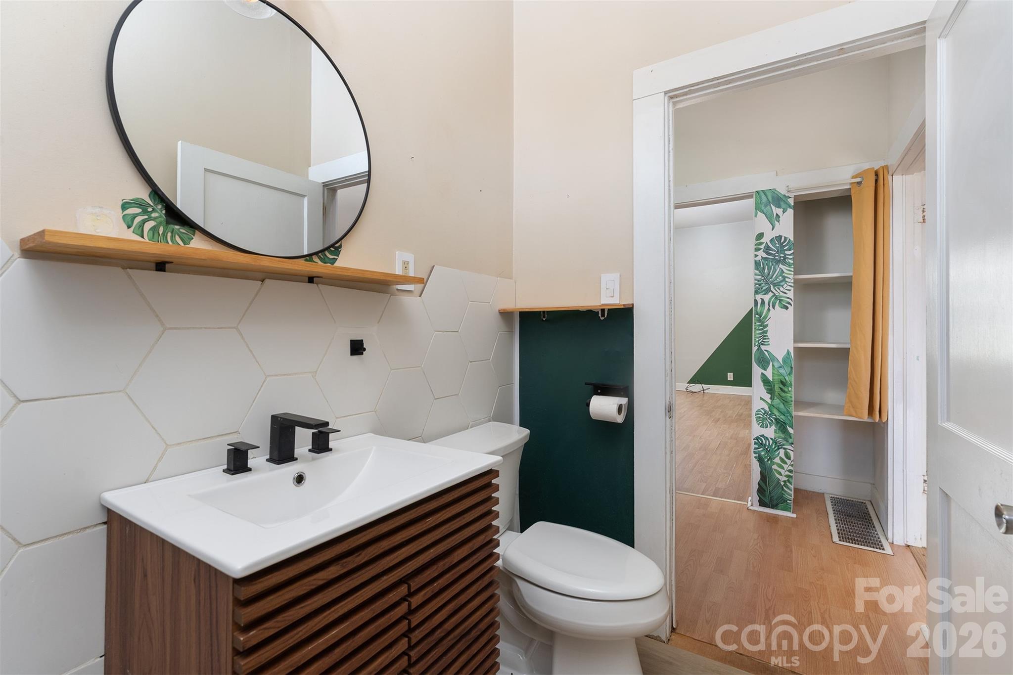 20 1st Street Marion, NC 28752 - Photo 6 of 23 a bathroom with a sink a mirror and a toilet