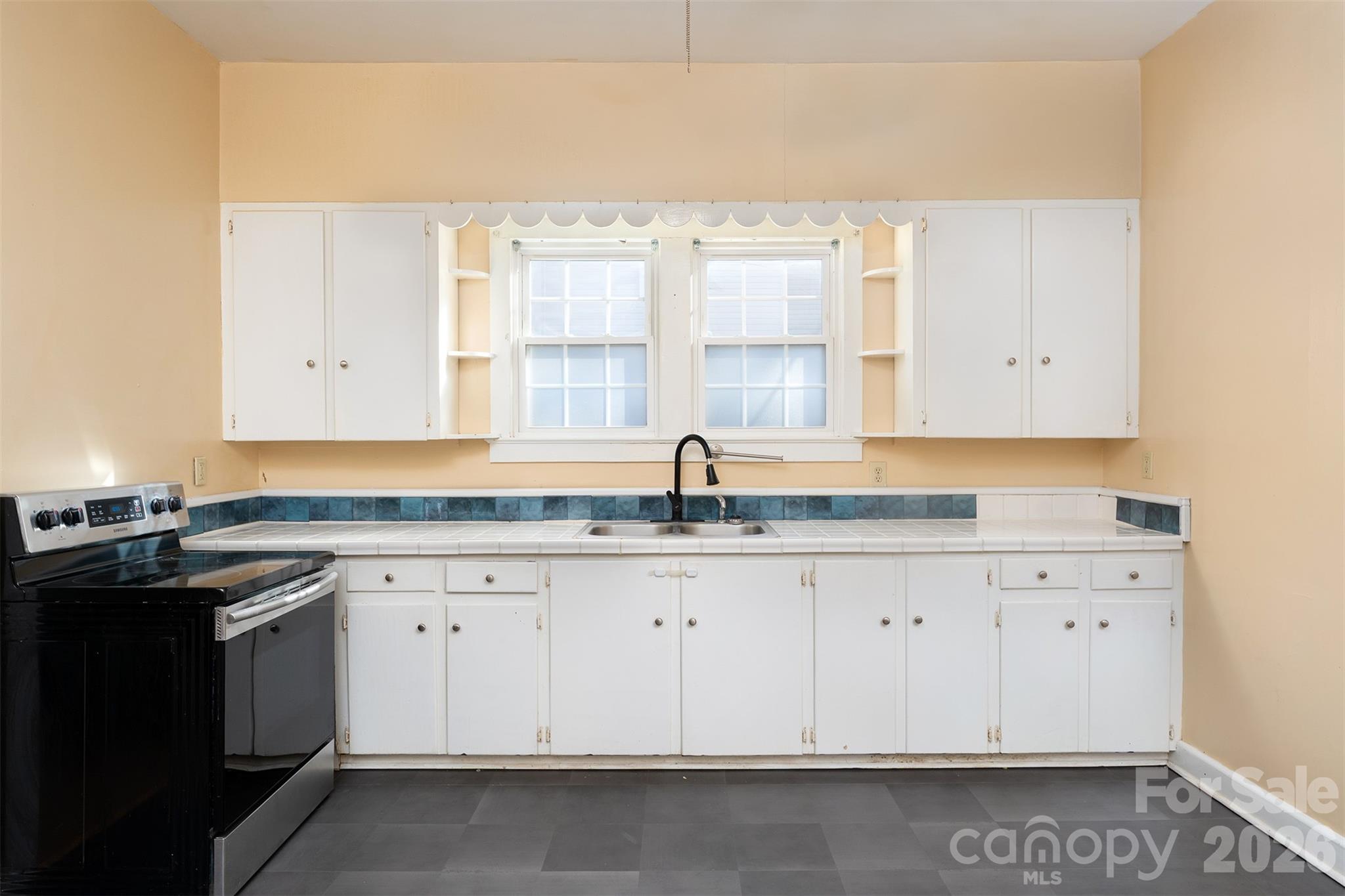 20 1st Street Marion, NC 28752 - Photo 9 of 23 a kitchen with granite countertop white cabinets and a sink