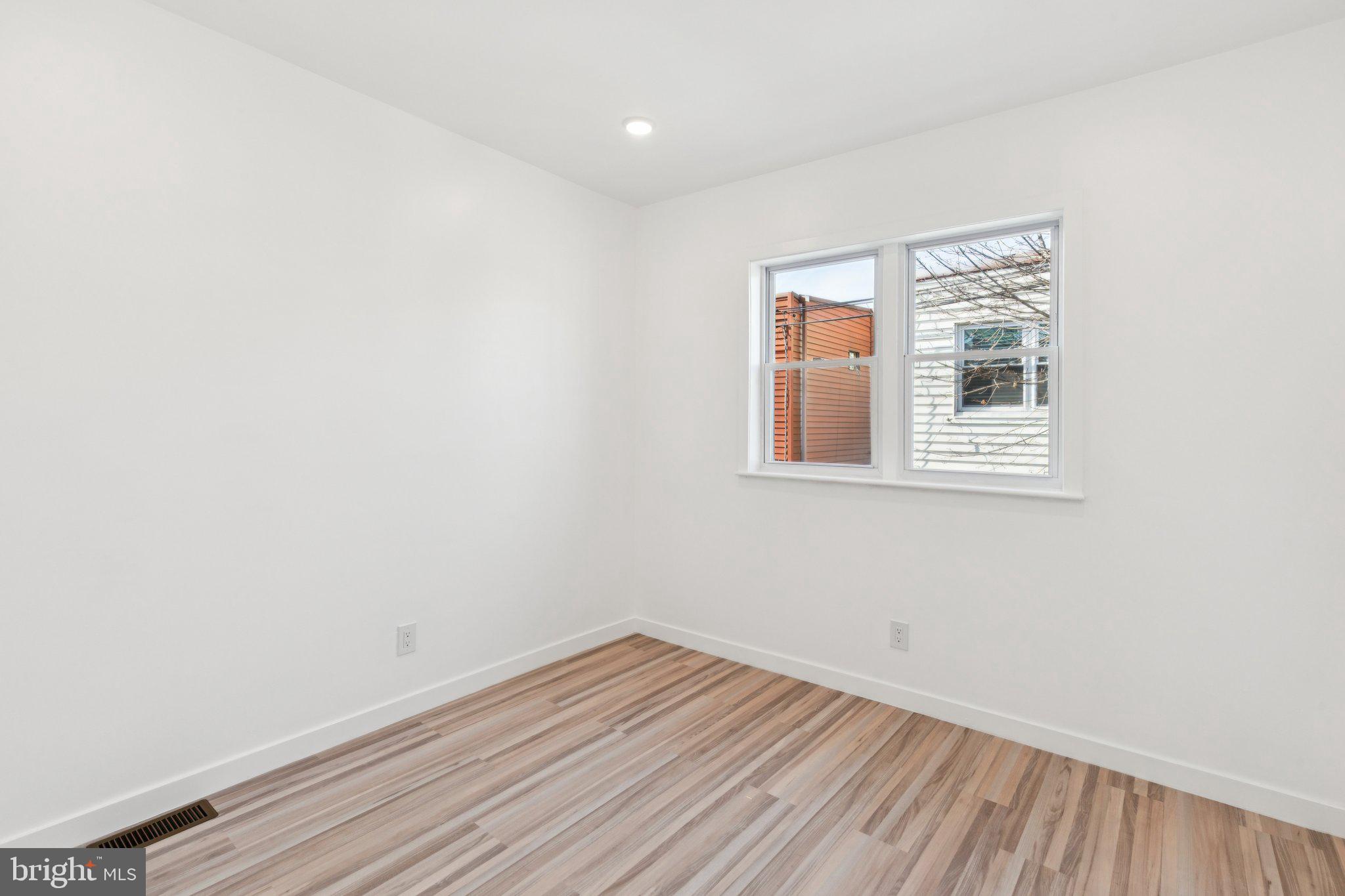 2242 South Bonsall Street Philadelphia, PA 19145 - Photo 11 of 21 a view of an empty room with wooden floor and a window