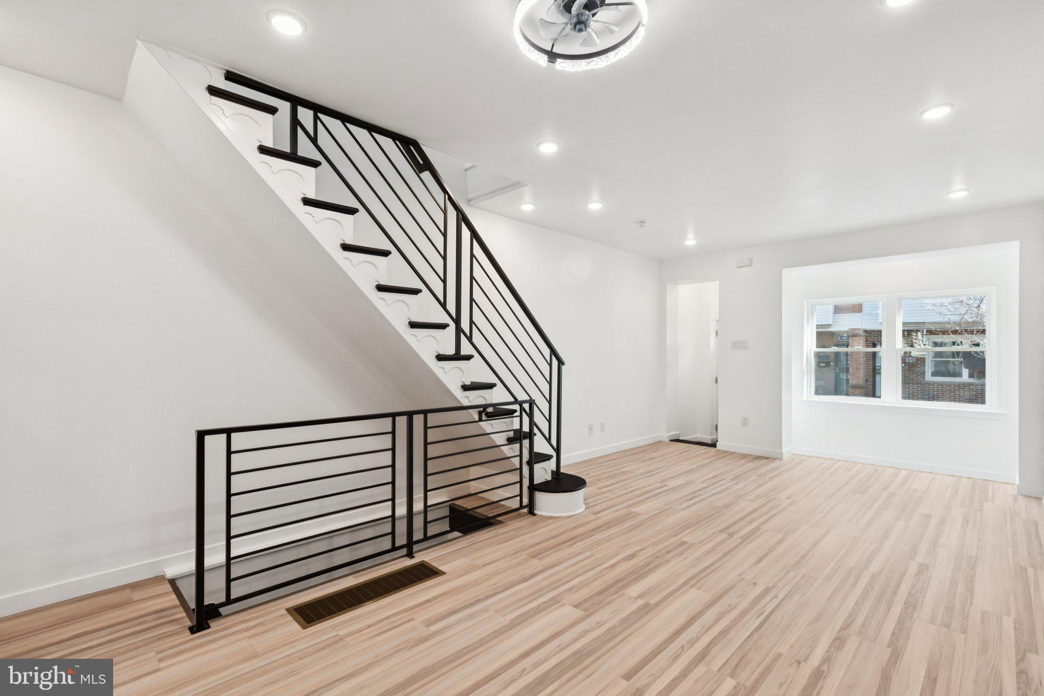 2242 South Bonsall Street Philadelphia, PA 19145 - Photo 3 of 21 a view of a hallway with wooden floor and stairs