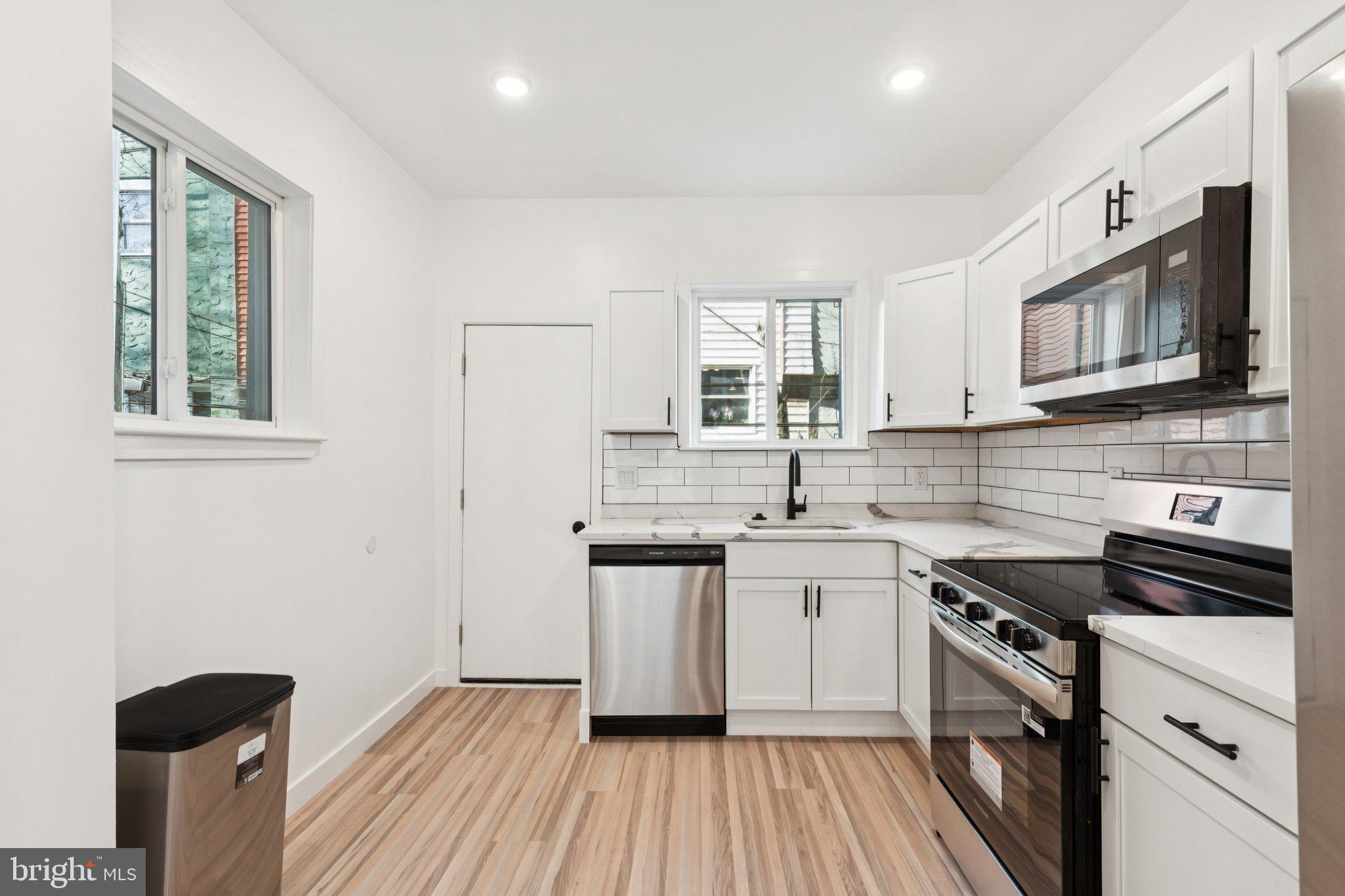 2242 South Bonsall Street Philadelphia, PA 19145 - Photo 6 of 21 a kitchen with stainless steel appliances granite countertop a sink stove and refrigerator