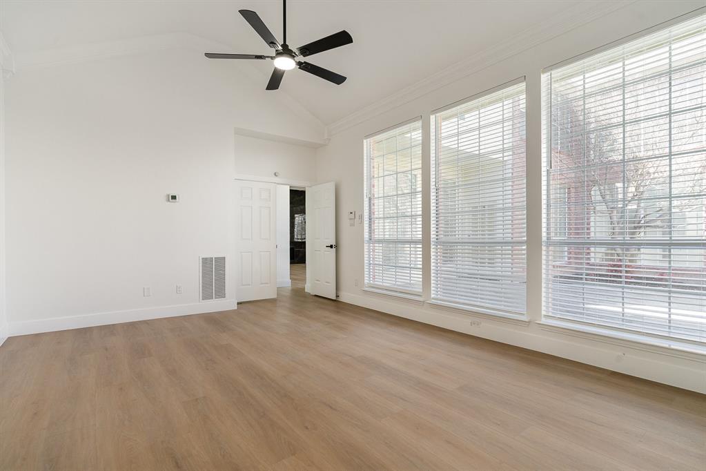 7524 Aberdon Road Dallas, TX 75252 - Photo 16 of 39 Empty room featuring baseboards, light wood-style flooring, visible vents, and crown molding