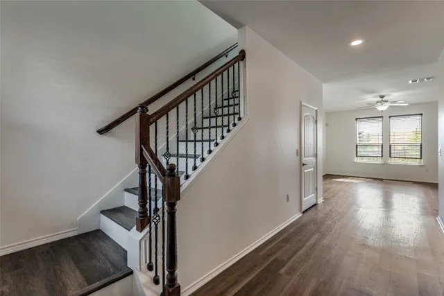 a view of an entryway with wooden floor and stairs
