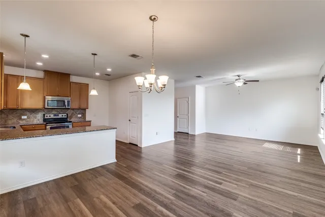 a view of a kitchen with a sink a refrigerator and a floor to ceiling window
