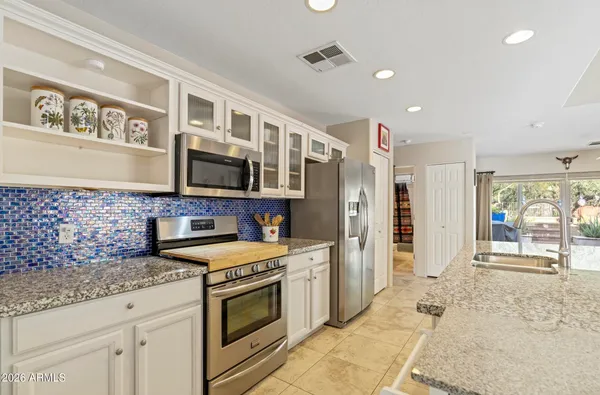 a kitchen with stainless steel appliances granite countertop a stove and a sink