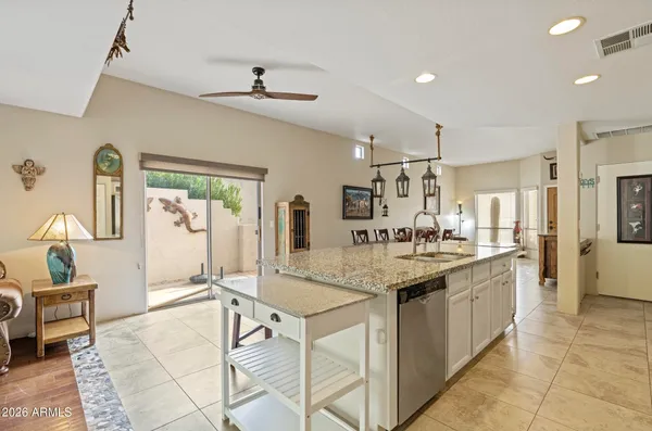 a kitchen with stainless steel appliances granite countertop a sink and cabinets
