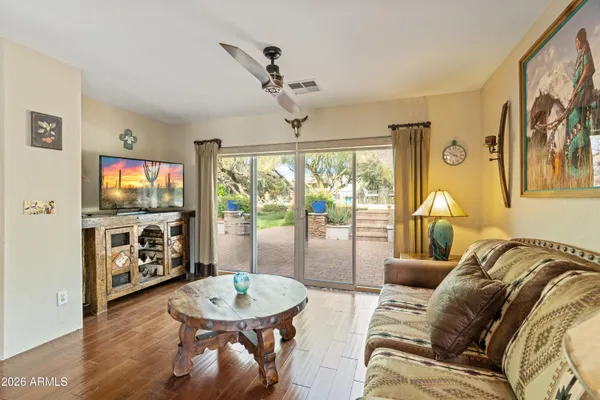 a living room with furniture a flat screen tv and a large window
